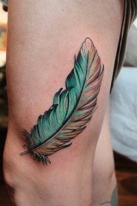 Cool_colored_feather_tattoo_on_thigh.jpg.pagespeed.ce.Qgn_VI8BI_