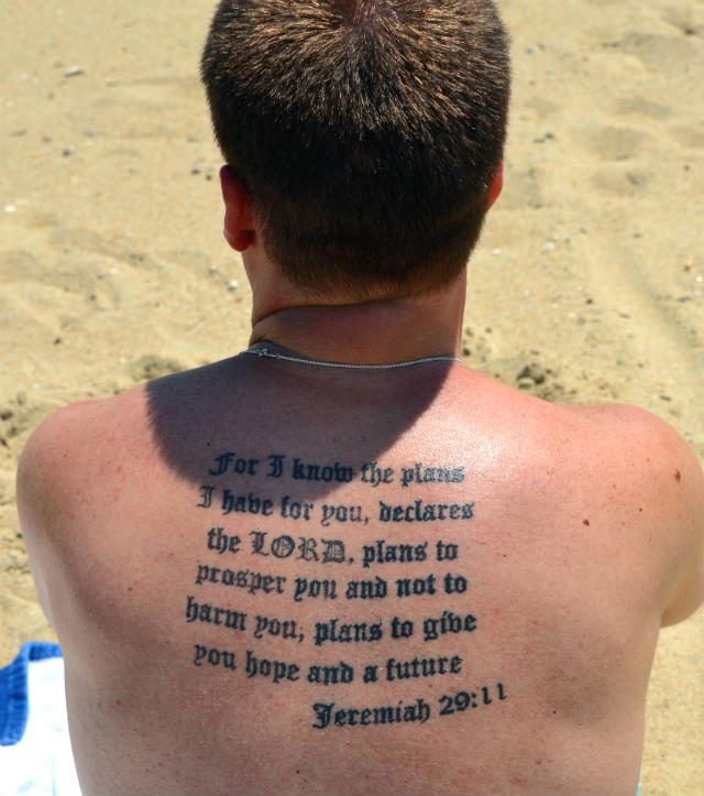a-man-on-the-beach-is-seen-with-jeremiah-2911-tattooed-on-his-back-in-this-june-30-2012-photo