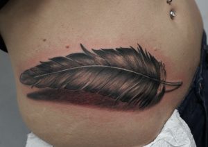 grey-ink-feather-tattoo-on-hip