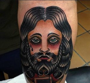 male-jesus-arm-tattoo-designs-with-old-school-style-ink