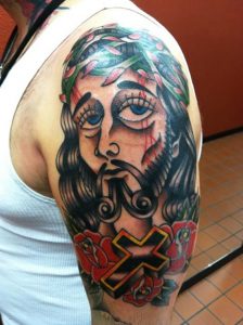 red-flowers-and-jesus-christ-head-tattoo-on-half-sleeve